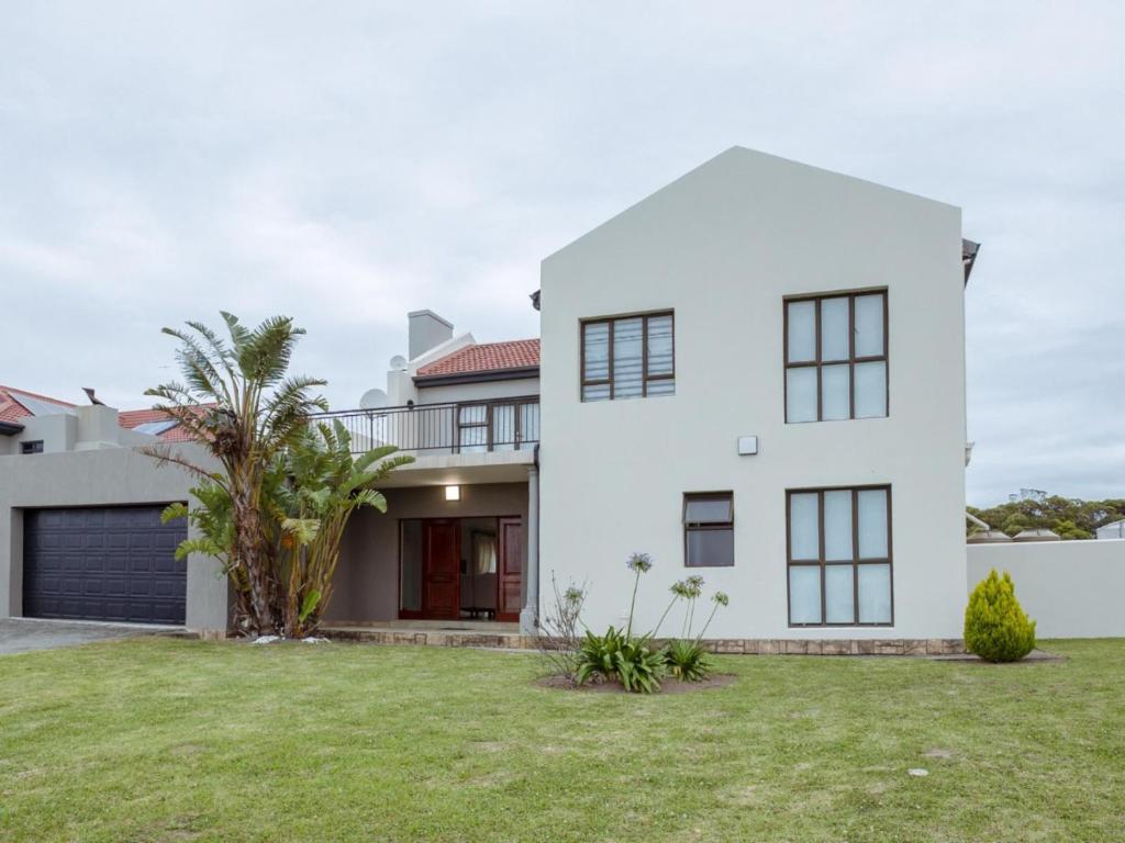 a white house with a yard at The Villa @ Balugha River Estate in Glengariff
