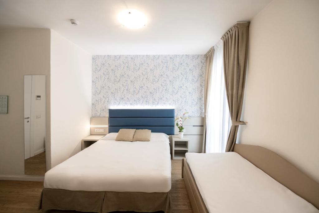 Postel nebo postele na pokoji v ubytování Hotel Astoria
