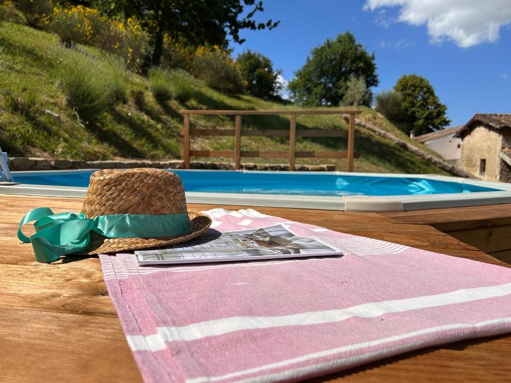 a straw hat sitting on a table next to a pool at La casa del Tiglio in Borgo San Lorenzo