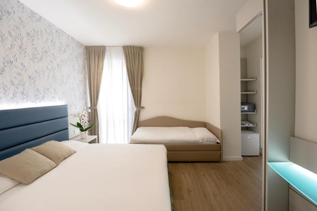 Postel nebo postele na pokoji v ubytování Hotel Astoria