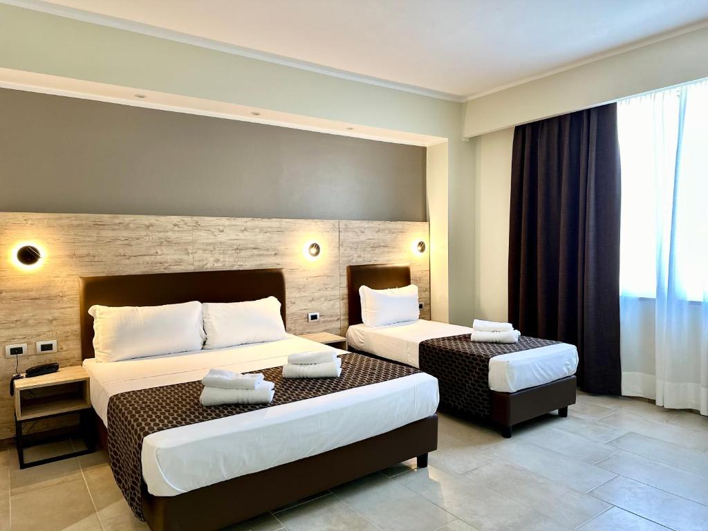 Postel nebo postele na pokoji v ubytování Hotel Giacosa