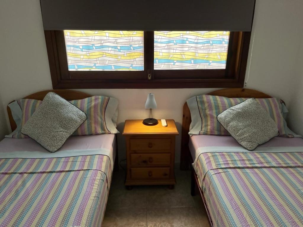 A bed or beds in a room at Vera Mar 5A Primera linea con Piscina y Parking
