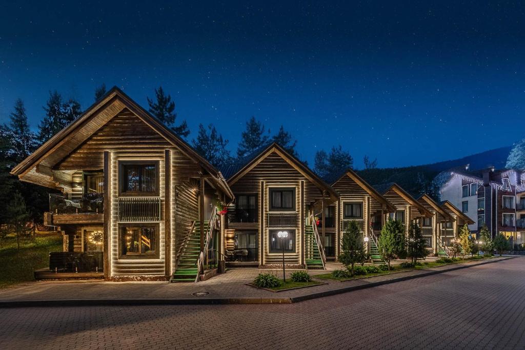 a row of houses on a street at night at Bukovel Hotel in Bukovel