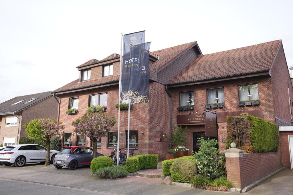 a brick building with a sign in front of it at Haus Fliederbusch in Borken
