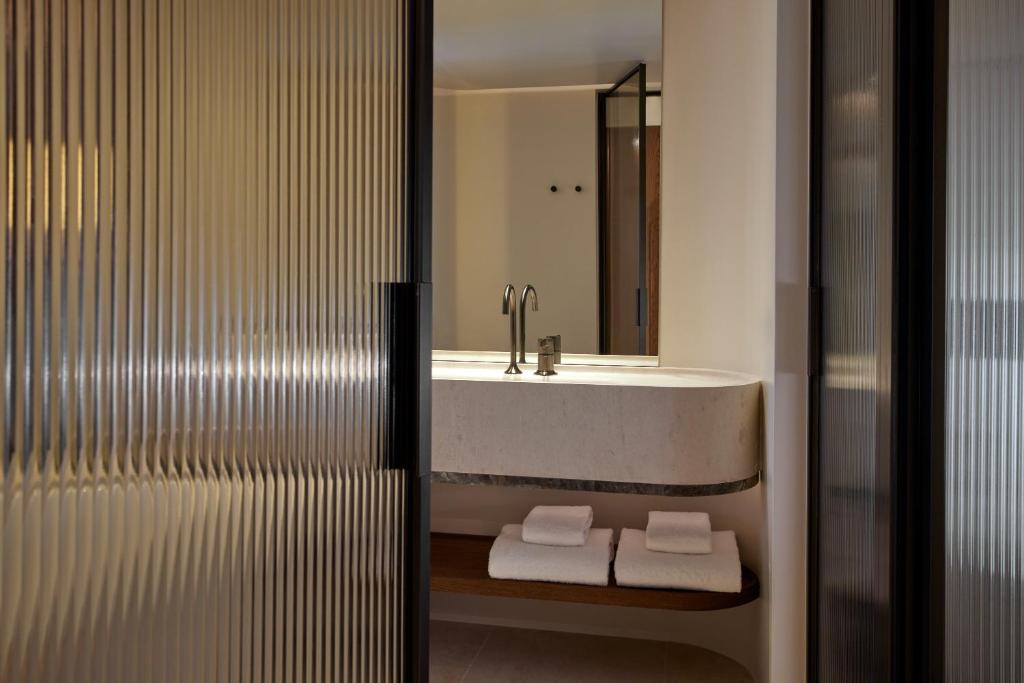 a bathroom with a sink and a mirror at Daios Cove in Agios Nikolaos