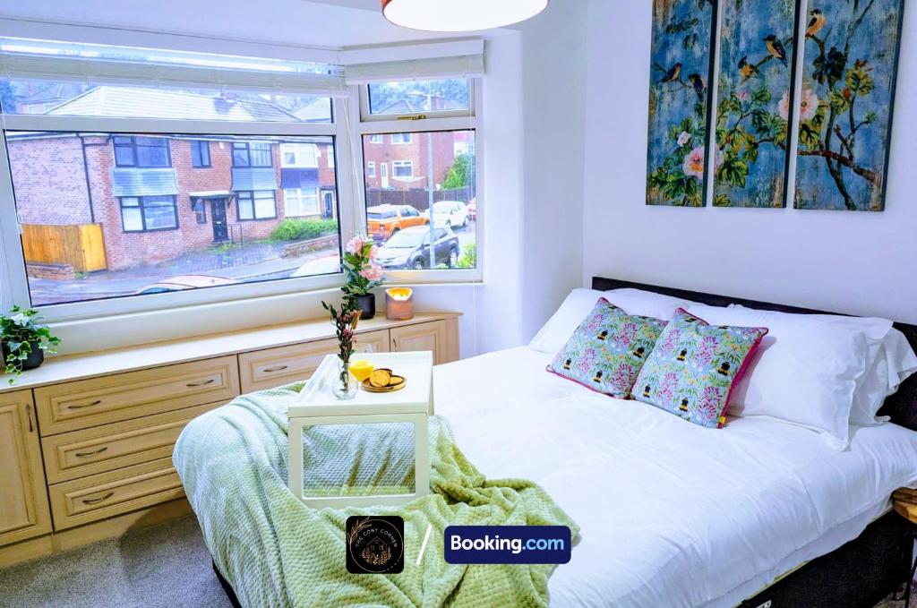 a small bedroom with a bed and a window at Modern 4-Bed House, Free Parking & WiFi in Swinton in Manchester