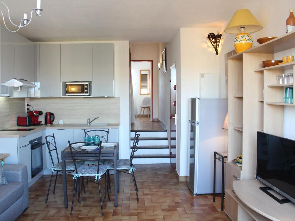 une cuisine et un salon avec une table et des chaises dans l'établissement Appartement Lumineux à 300m Plage, Balcon et Parking - 3 Couchages - FR-1-229C-22, à Port-la-Nouvelle