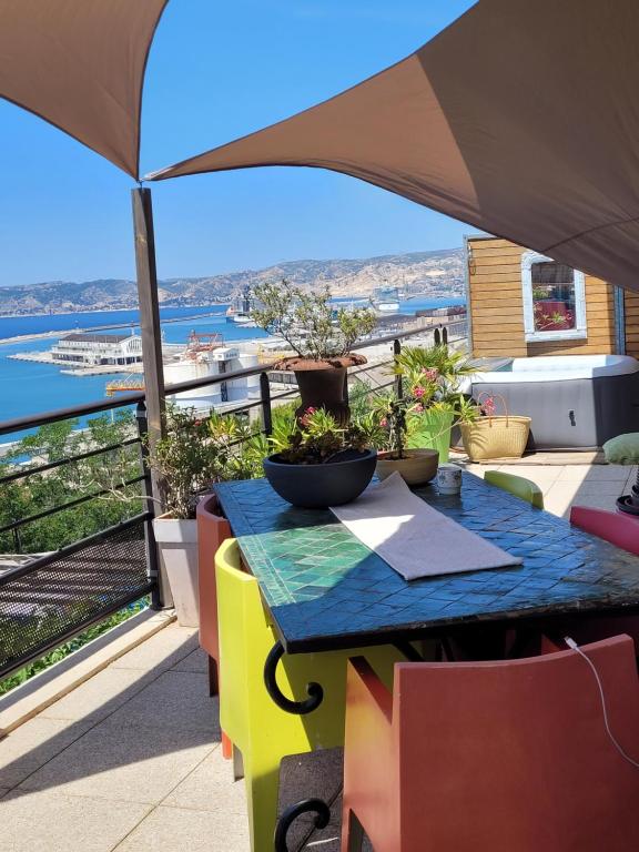 une table sur un balcon avec vue sur l'eau dans l'établissement Marseille autrement Appartement dans résidence calme avec vue sur mer, à Marseille