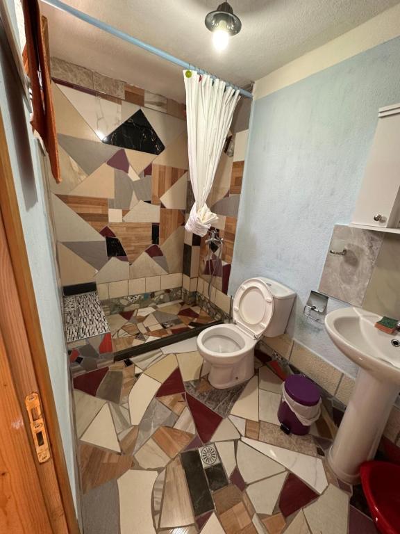 a bathroom with a toilet and a sink at Villa Zeko in Gjirokastër