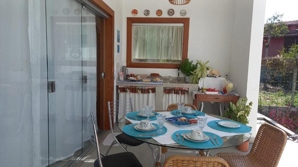a table with blue plates on it in a kitchen at Brisa Mar Suítes in Arraial d'Ajuda