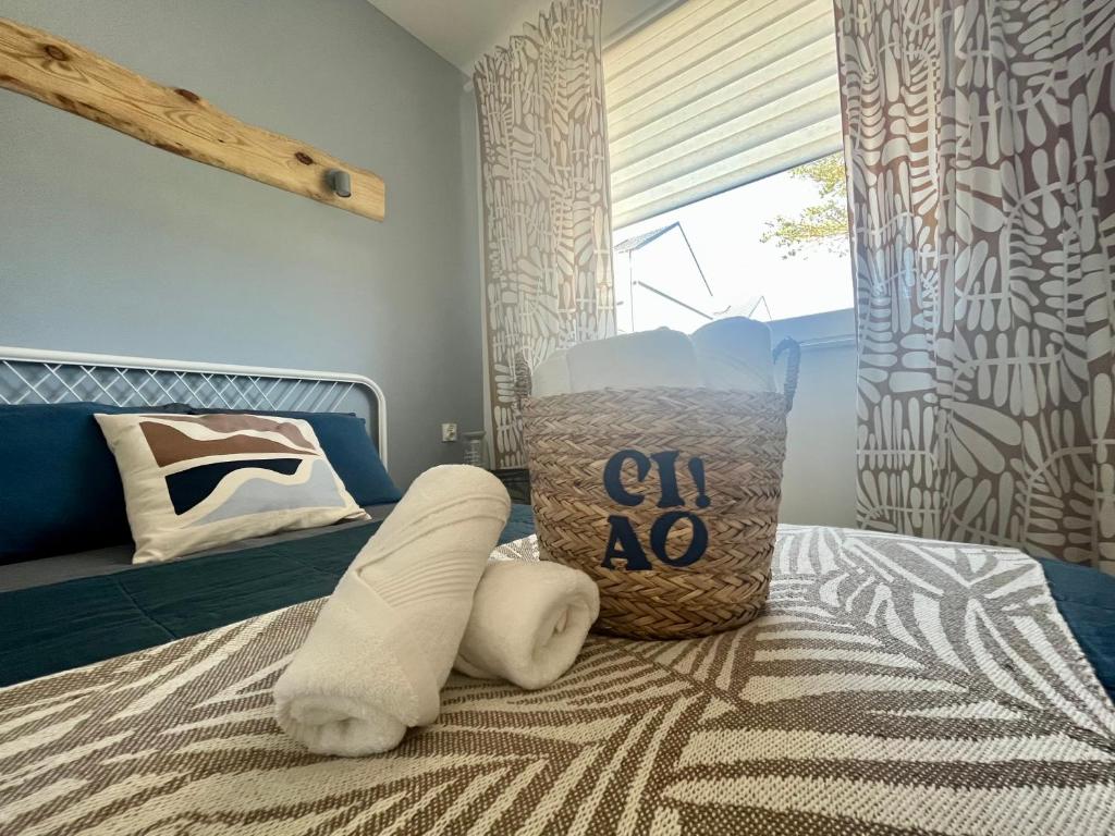 a bedroom with a bed with pillows on it at Cosy waves apartment in Tupadła