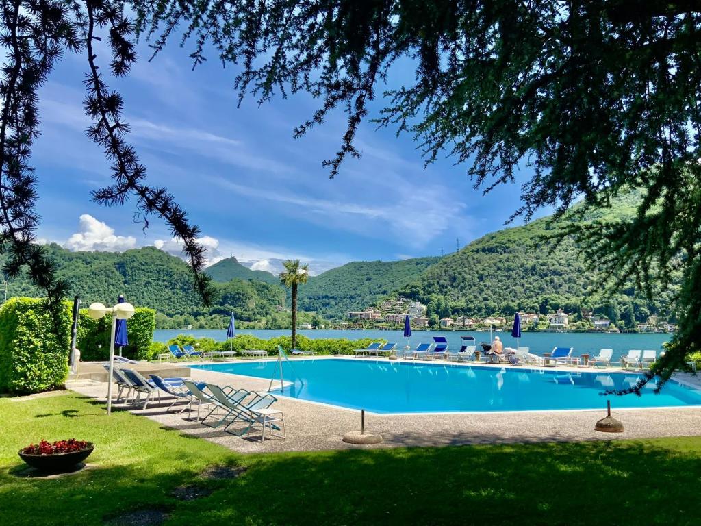 a pool with lounge chairs and a view of the water at Casa Giò in Brusimpiano