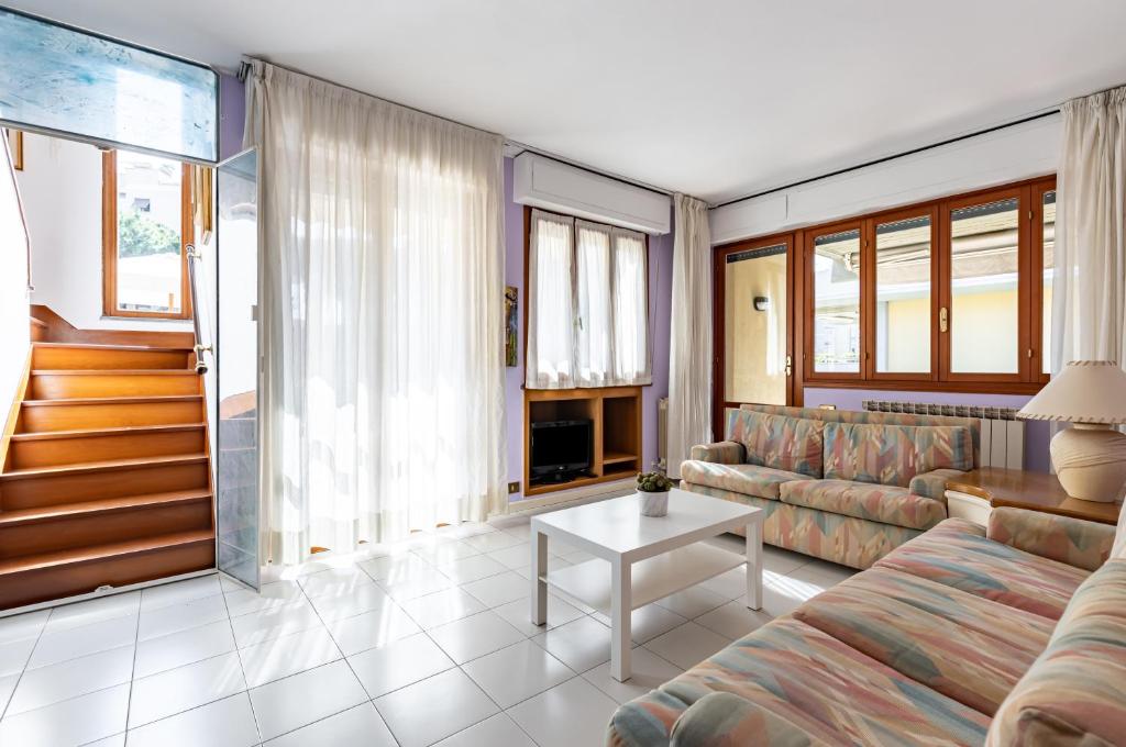 a living room with a couch and a table at Two-Levels Apartment with Terrace and Parking in Viareggio