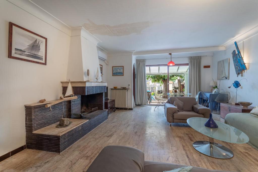 a living room with a couch and a fireplace at Villa de famille Maragre, au calme in Sainte-Marie-la-Mer
