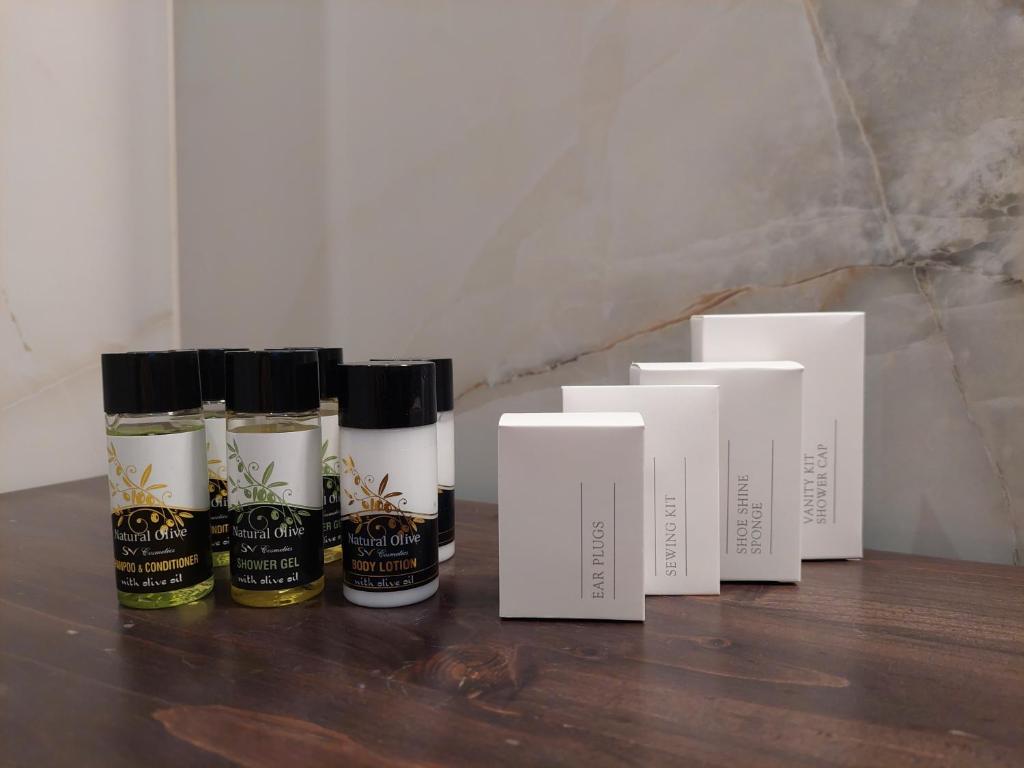 a group of four bottles of essential oils on a table at Blue Bay Hotel in Iraklitsa