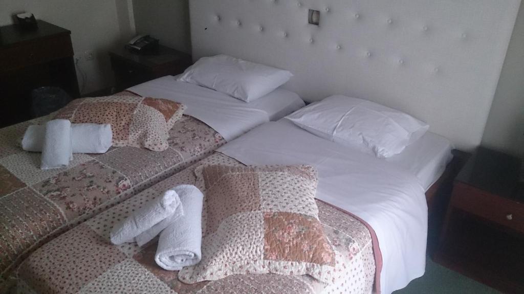 Postel nebo postele na pokoji v ubytování Hotel Villa Tasko