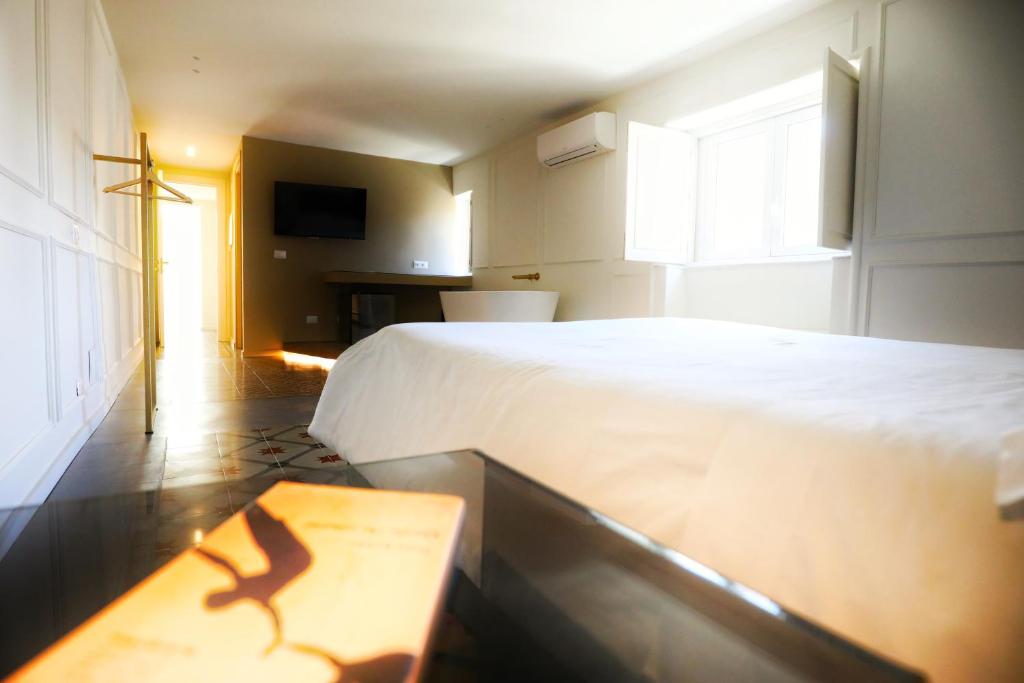 Postel nebo postele na pokoji v ubytování Teatro Suites Rooms