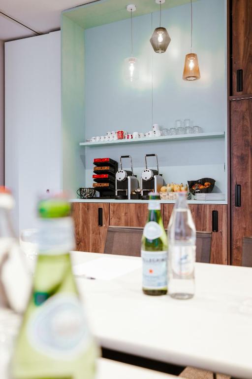 two bottles of wine sitting on a counter in a kitchen at Ibis Luxembourg Airport in Luxembourg