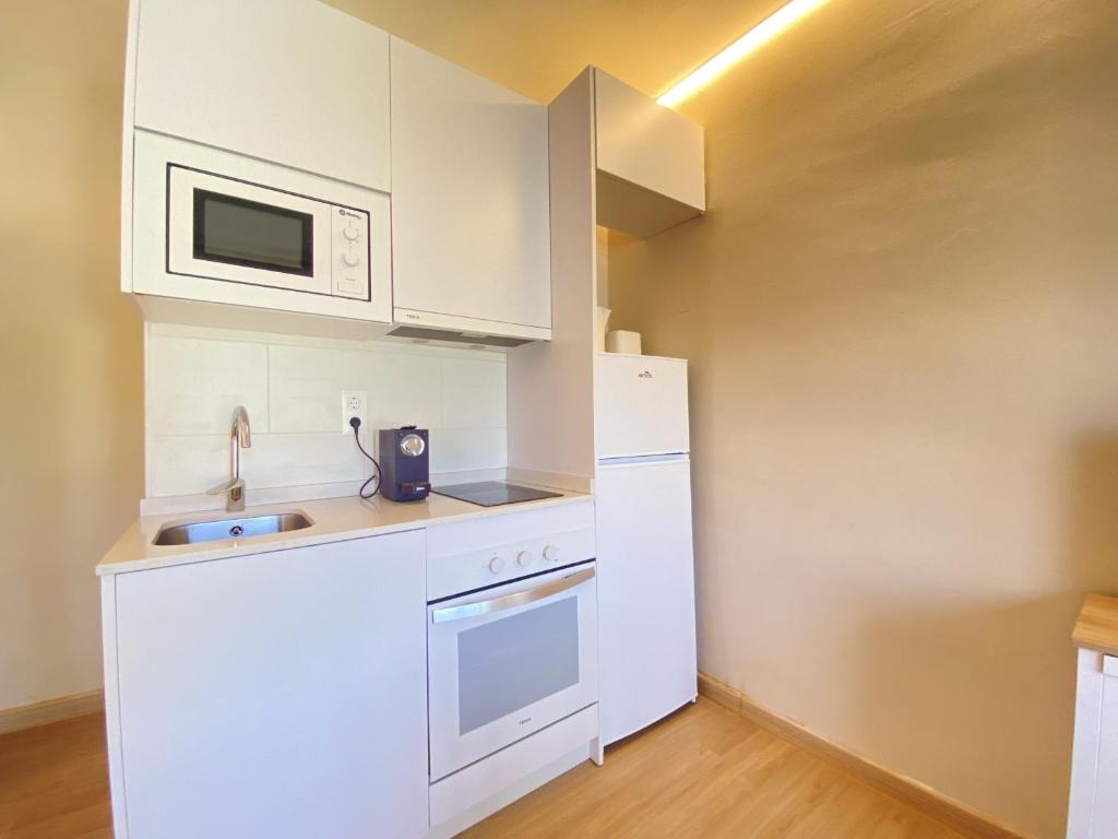 A kitchen or kitchenette at R126 Beachfront Apartment Sant Salvador