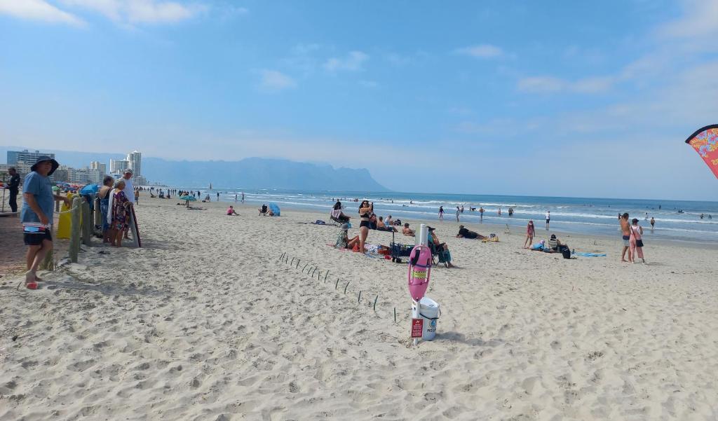 a group of people on a beach with a kite at St Tropez on the beach in Strand
