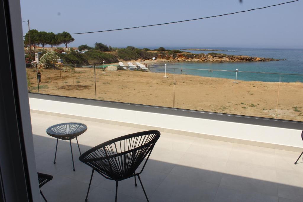 a room with two chairs and a view of a beach at BEACH WHITE VILLAs three bedroom in Minia