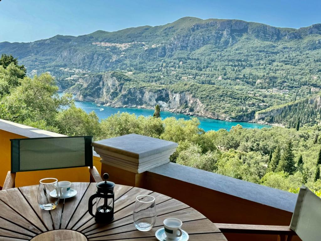 a table with a view of a river and mountains at Sea View Villa - Close from Beach - Rovinia in Liapades