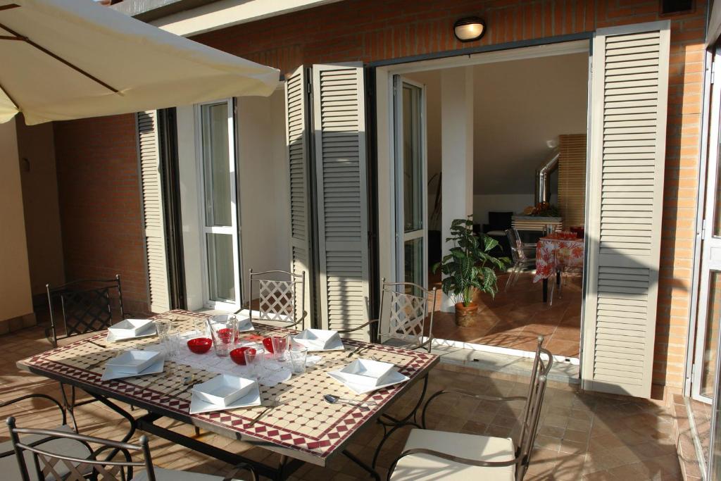 a table and chairs on a patio with an umbrella at Sinfonia Martini in Verbania