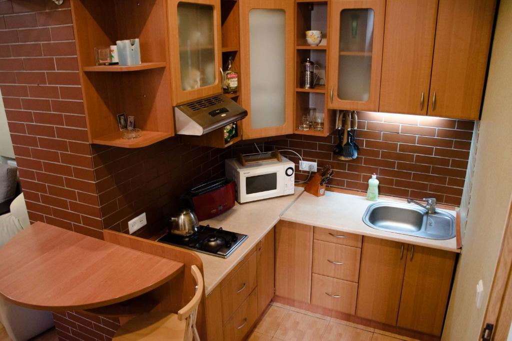 リヴィウにあるInLviv Apartmentsの小さなキッチン(シンク、電子レンジ付)