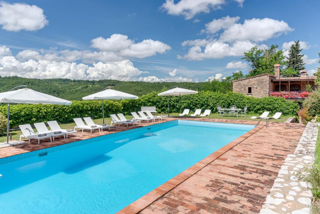 ガンバッシ・テルメにあるTenuta Acquabona - intero casaleのスイミングプール(椅子、パラソル付)