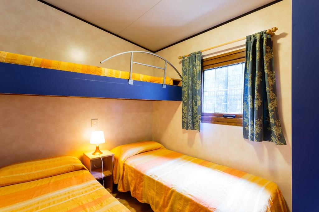 Letto o letti in una camera di Arcobaleno Village