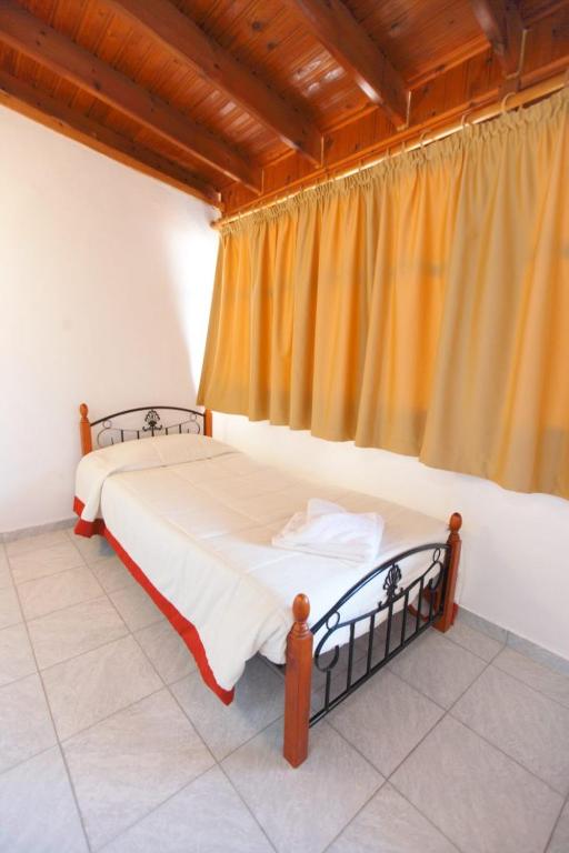A bed or beds in a room at Theofilos Classic Hotel