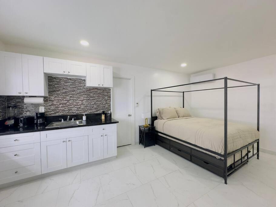 a bedroom with a bed and a sink in it at New Mid Miami Beach apt free parking and beach access in Miami Beach