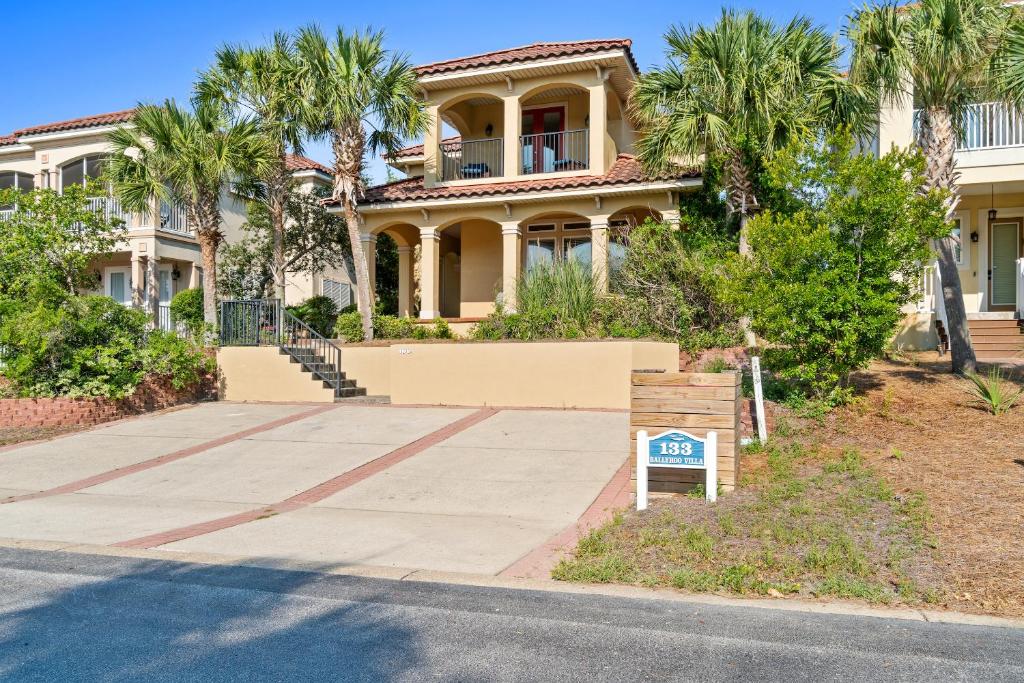 a house with a sign in front of it at La Valencia Villas in Rosemary Beach