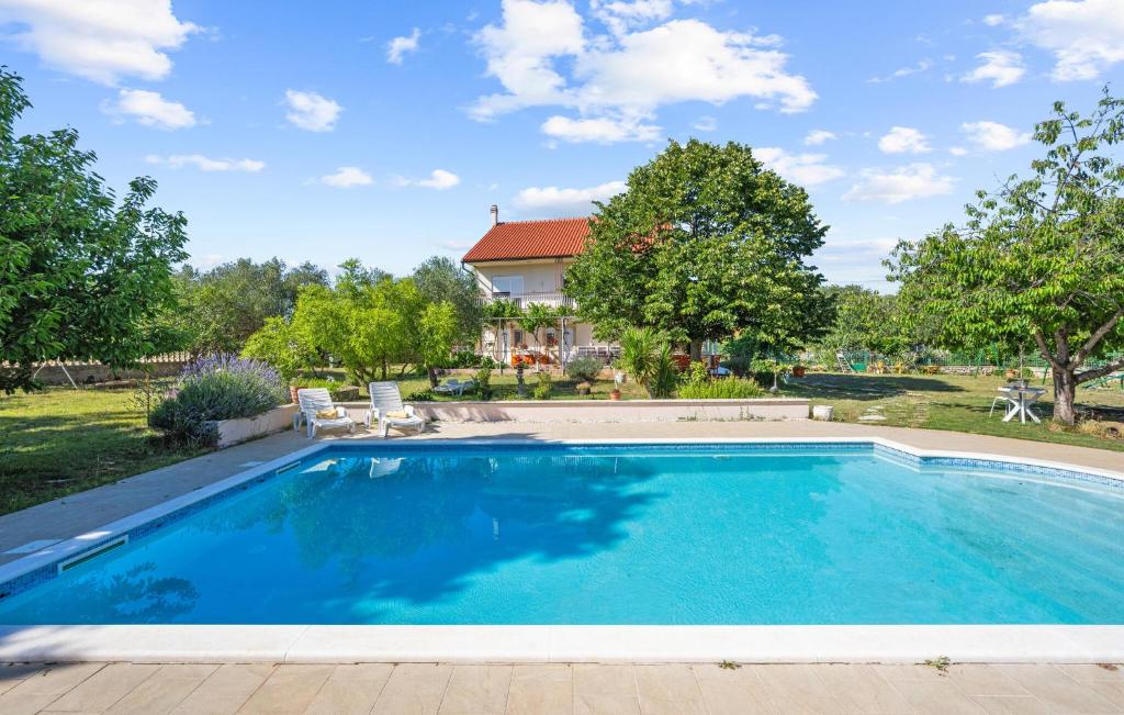 a swimming pool in a yard with a house at Stunning Apartment In Lozovac With Wifi in Lozovac