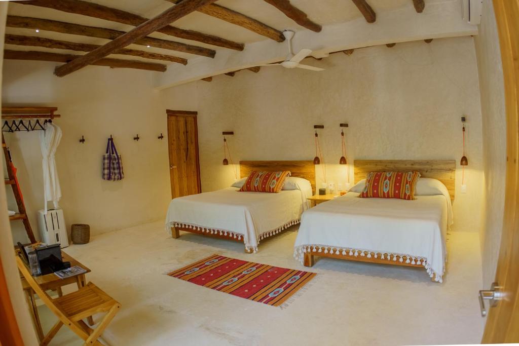 Postel nebo postele na pokoji v ubytování Hotel Poc Na Tulum