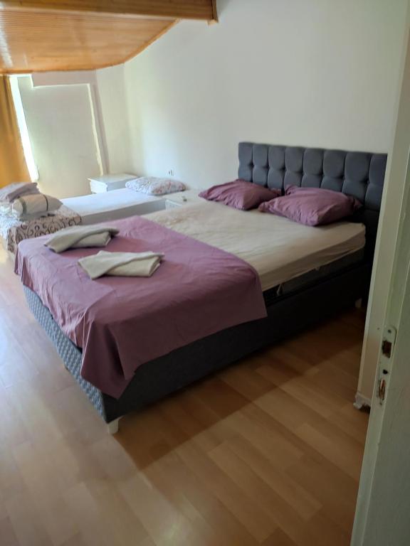 A bed or beds in a room at Garden Prizma Rooms&Aparts