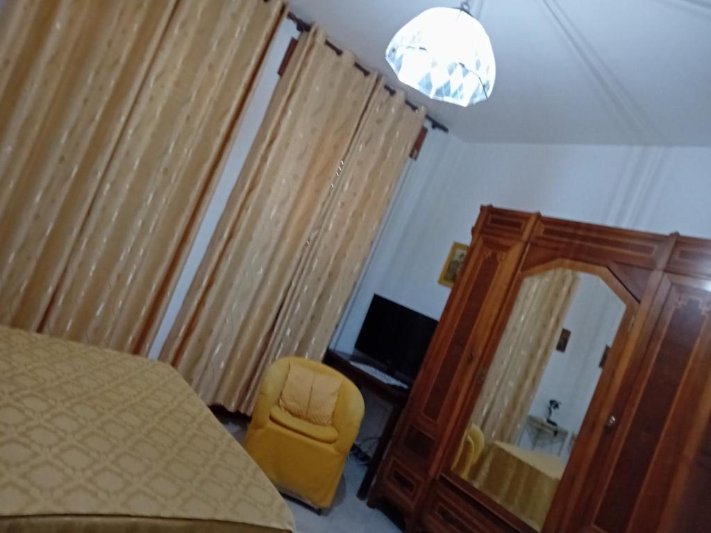 a bedroom with a bed and a mirror and a chair at B&B il Girasole in Corridonia