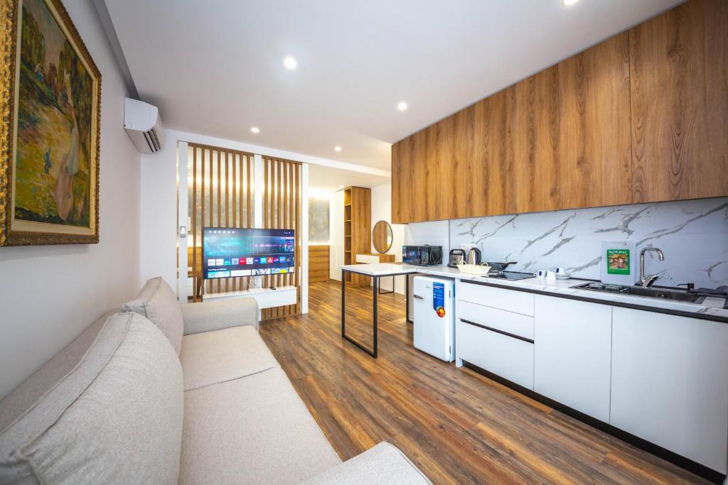 a living room with a couch and a kitchen at Downtown Boutique Studios in Tirana