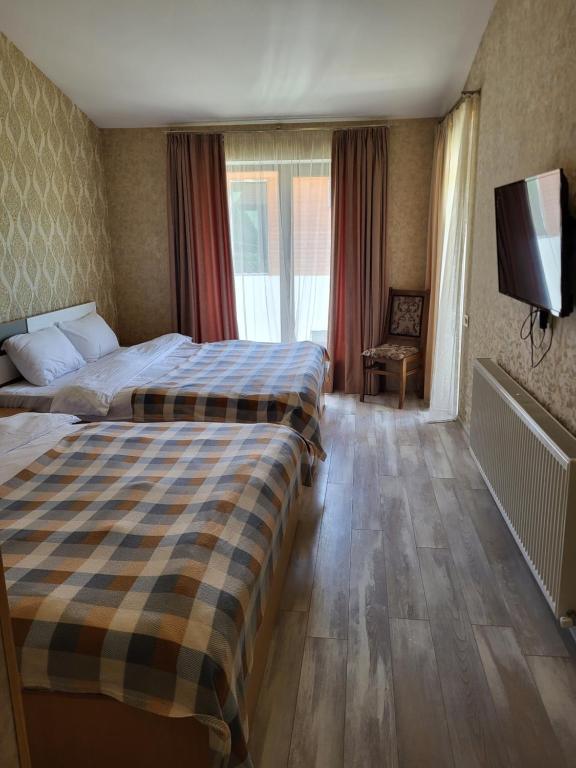 Postel nebo postele na pokoji v ubytování Villa Megobrebi
