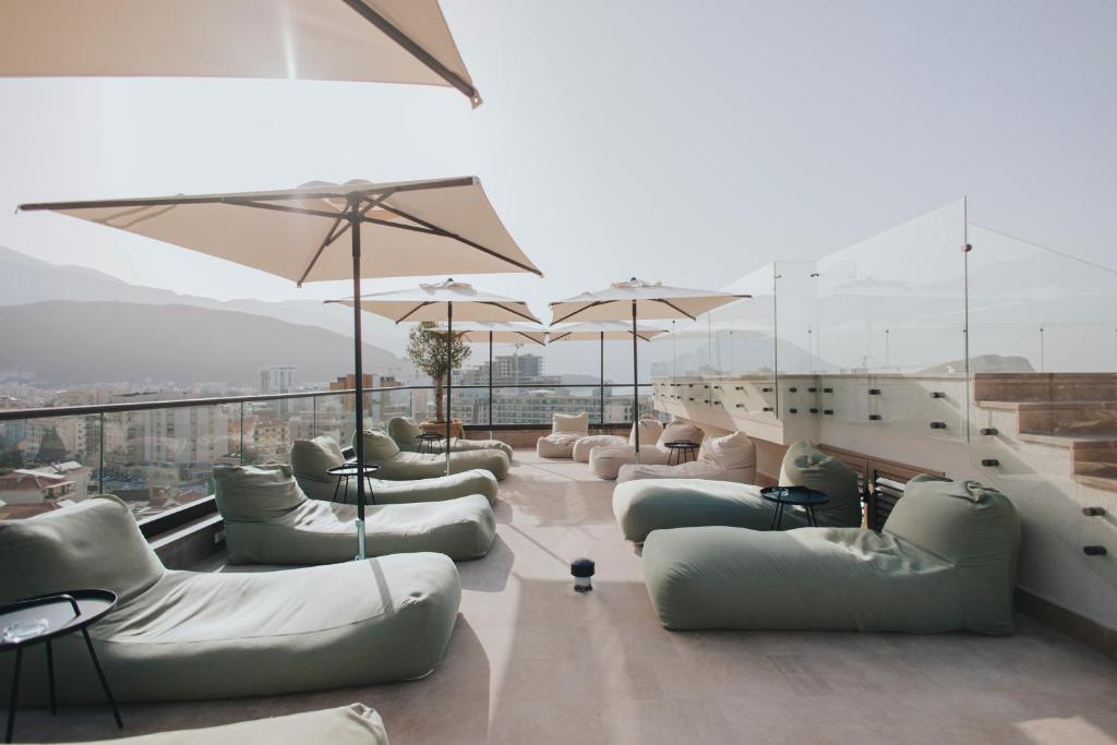 a waiting room with couches and umbrellas at Infinity Hotel & More in Budva