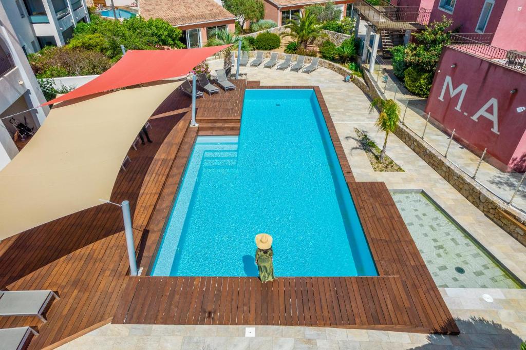 an overhead view of a swimming pool on a wooden deck at Les Alizés Résidence & Spa in LʼÎle-Rousse