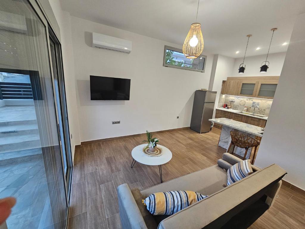 a living room with a couch and a table at Cute Corner in Khalkoútsion