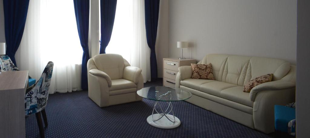 a living room with a couch and two chairs and a table at Five Points Square - City Center in Belgrade