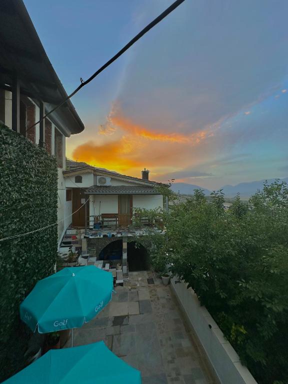 a view of a house with an umbrella on a patio at Villa Zeko in Gjirokastër