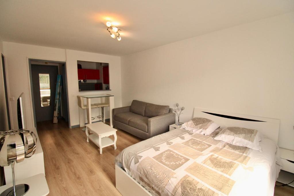 une chambre avec un lit, une chaise et un bureau dans l'établissement Residence les Flots Bleu Trouville-sur-Mers, à Trouville-sur-Mer