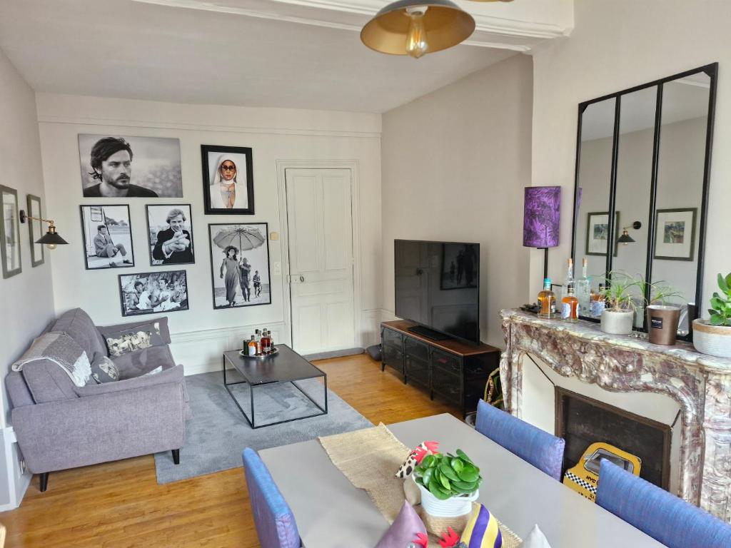 un salon avec un canapé et une cheminée dans l'établissement Le Monde d'Alex, à Troyes