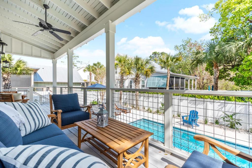 a patio with a table and chairs and a pool at Uncloudy Day - 1216 Demere Road in Mallory Park