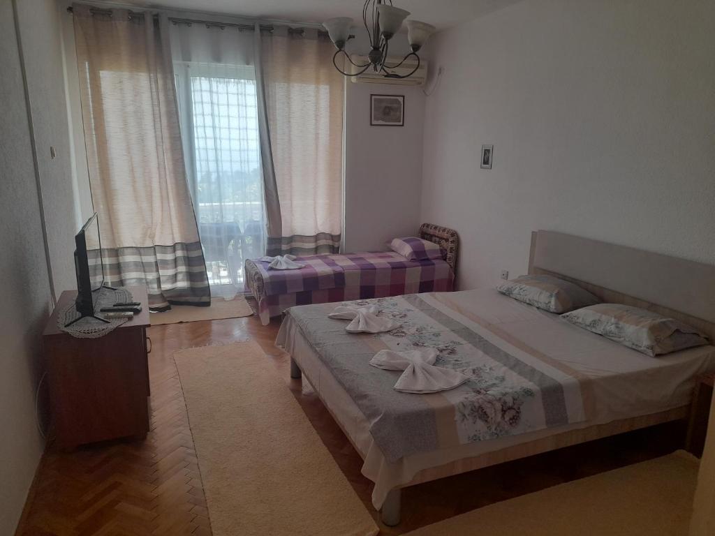 Postel nebo postele na pokoji v ubytování Tina Rooms