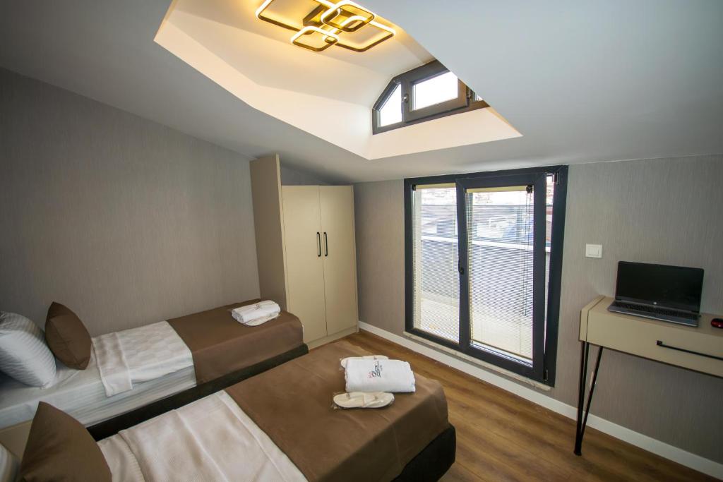 a small room with two beds and a window at Luxury Life Suites in Istanbul