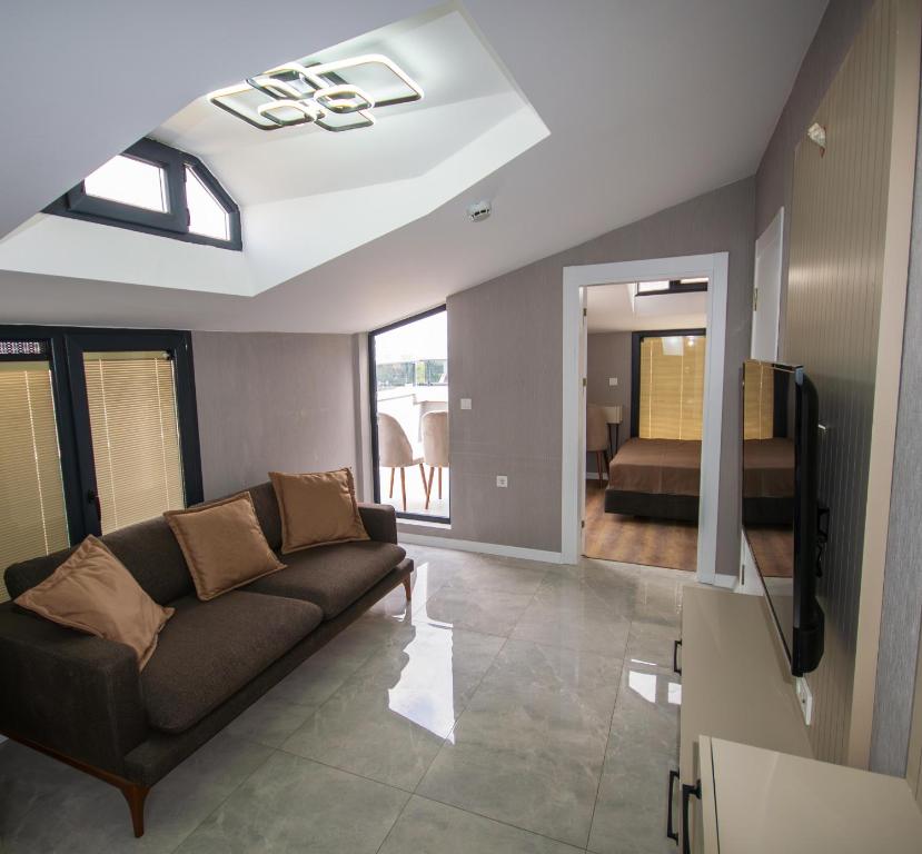 a living room with a couch and a television at Luxury Life Suites in Istanbul
